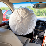Deployed Airbag in Beige Sedan Interior